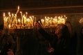 People light candles during festive prayer in church Royalty Free Stock Photo